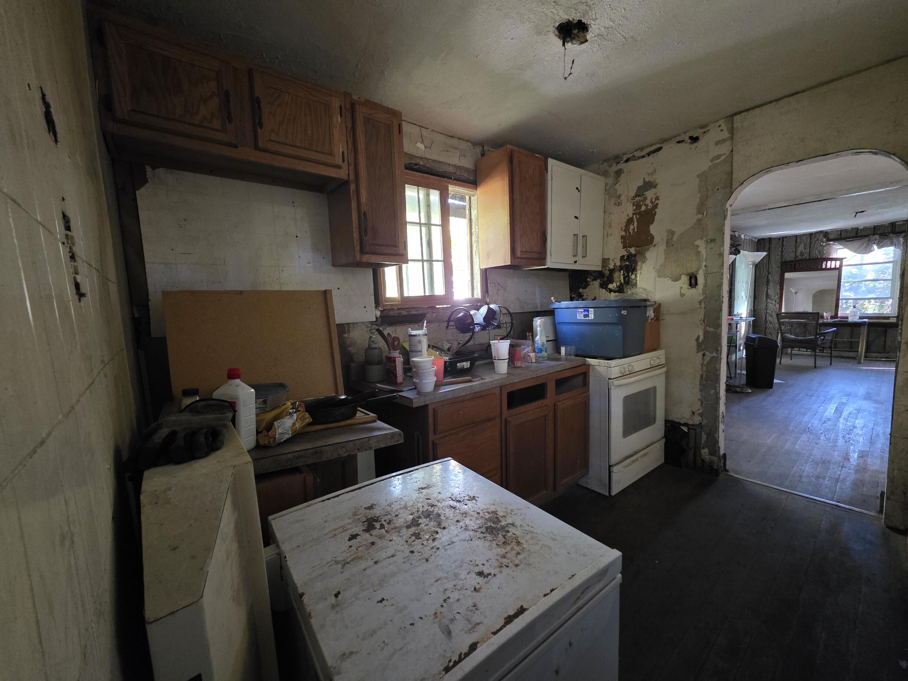 772 Ohio Street Gary, IN 46402 - Photo 6 of 22 a kitchen with a stove a refrigerator and a dining table