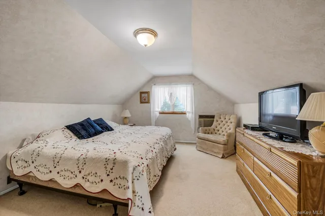 a bedroom with a bed a couch and dresser