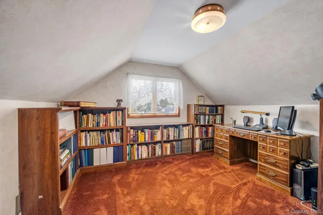 a bedroom with furniture and a book shelf