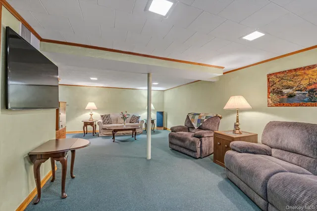 a living room with furniture and a lamp