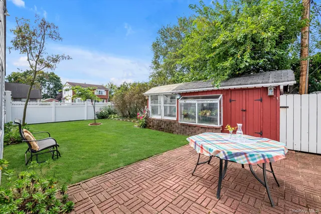 a backyard of a house with table and chairs