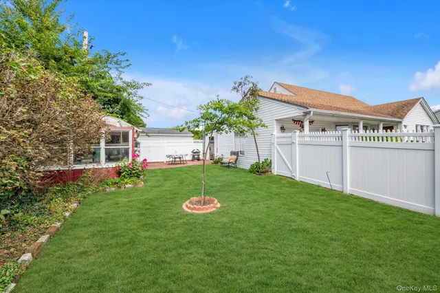 a view of a house with a backyard and a garden