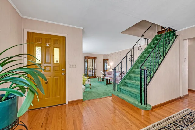 a view of entryway with wooden floor and stairs