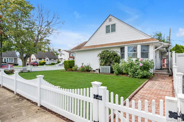 a front view of house with yard and green space