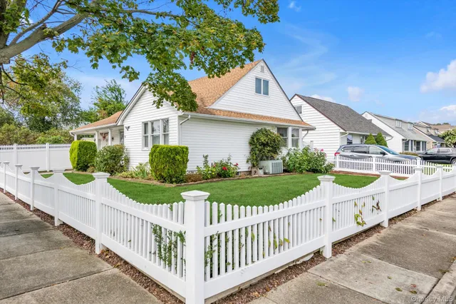 a view of a house with wooden fence