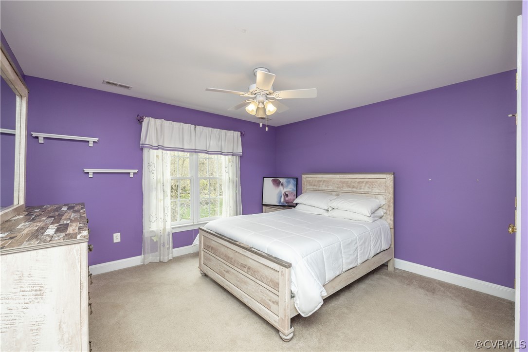 13201 Tipple Point Road Midlothian, VA 23114 - Photo 23 of 50 a bedroom with a bed chandelier and a window