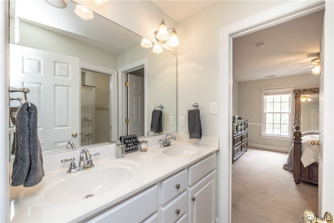 13201 Tipple Point Road Midlothian, VA 23114 - Photo 29 of 50 a bathroom with double vanity sinks a large mirror and a shower
