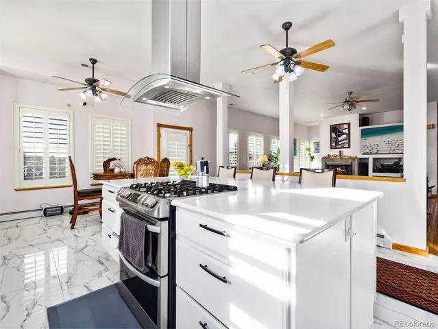 a kitchen with stainless steel appliances granite countertop a sink a stove and a refrigerator