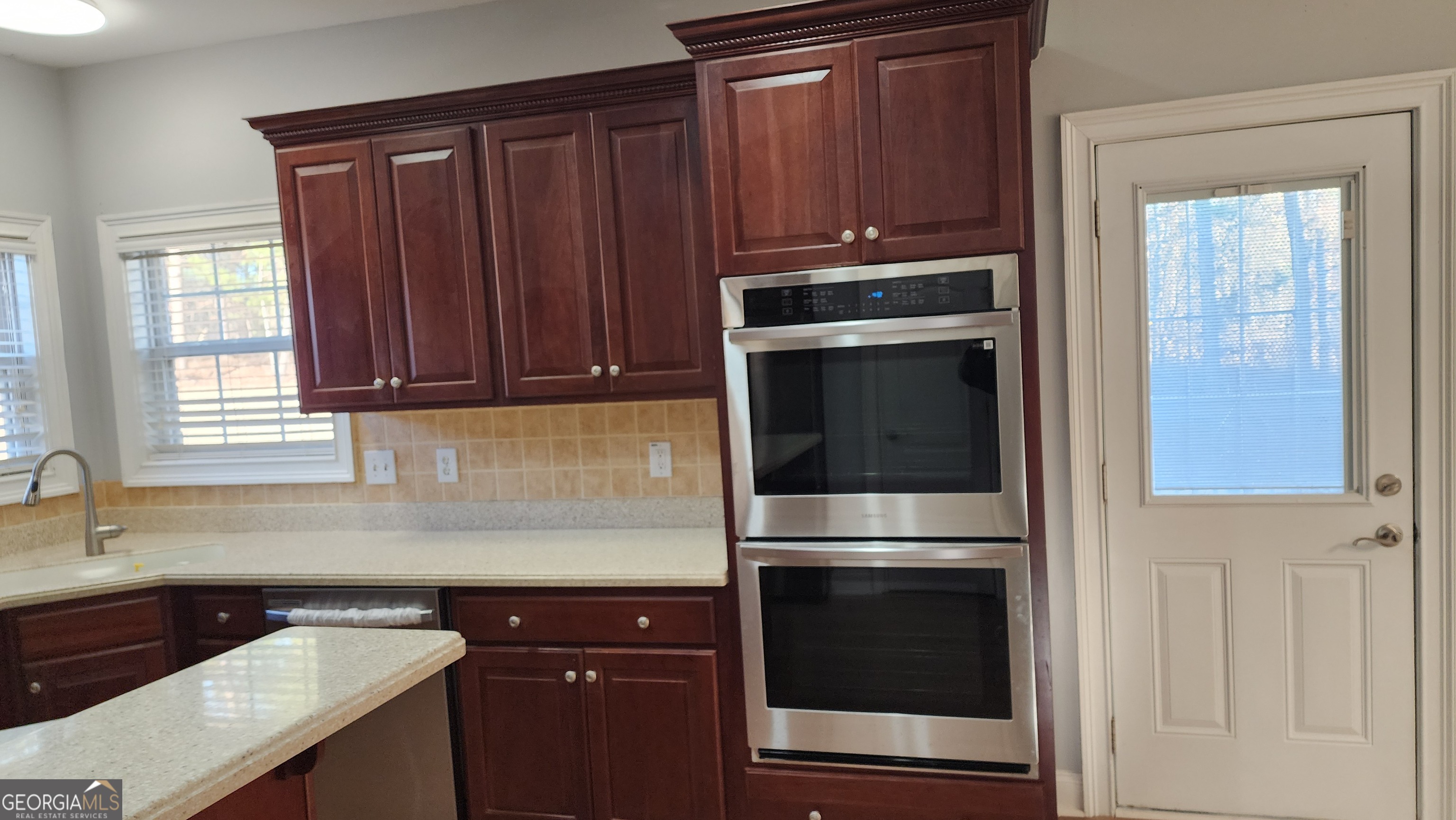 12123 Edgewater Drive Hampton, GA 30228 - Photo 12 of 44 a kitchen with a sink and a microwave