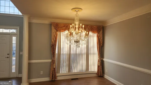 a small space with a window and a fan
