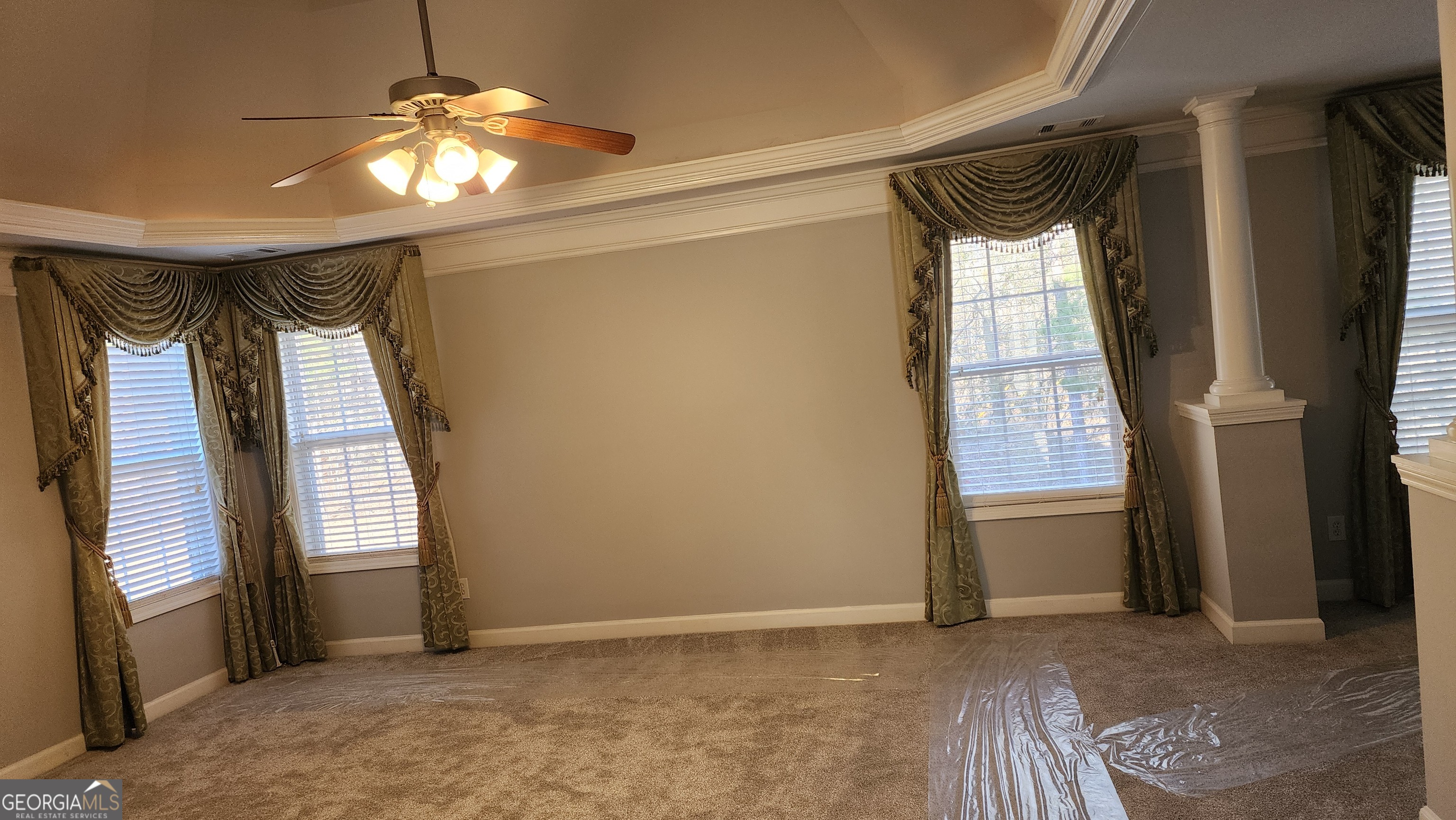 12123 Edgewater Drive Hampton, GA 30228 - Photo 16 of 44 a view of empty room with wooden floor and fan
