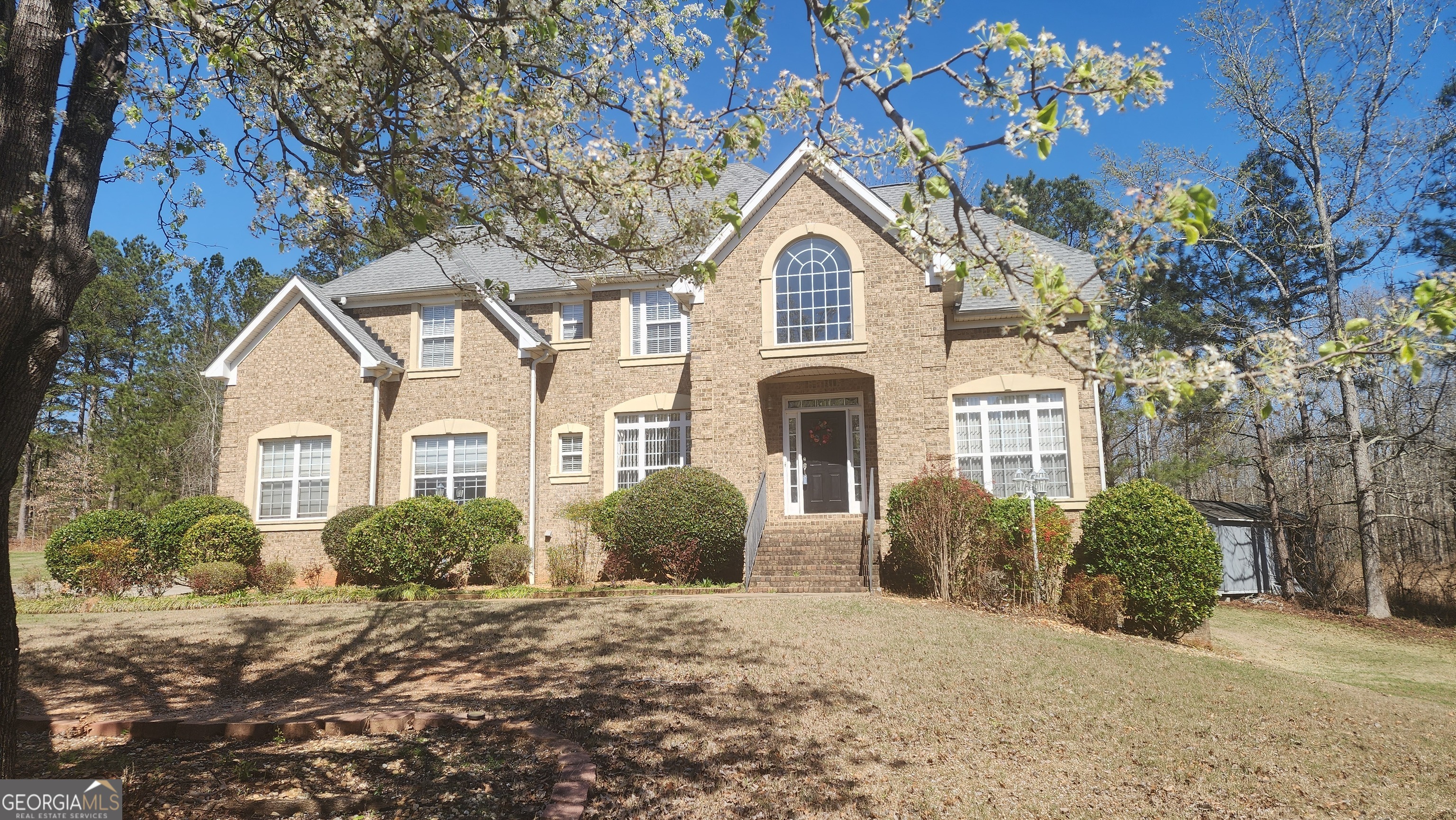 12123 Edgewater Drive Hampton, GA 30228 - Photo 2 of 44 a view of a white house with a yard and plants
