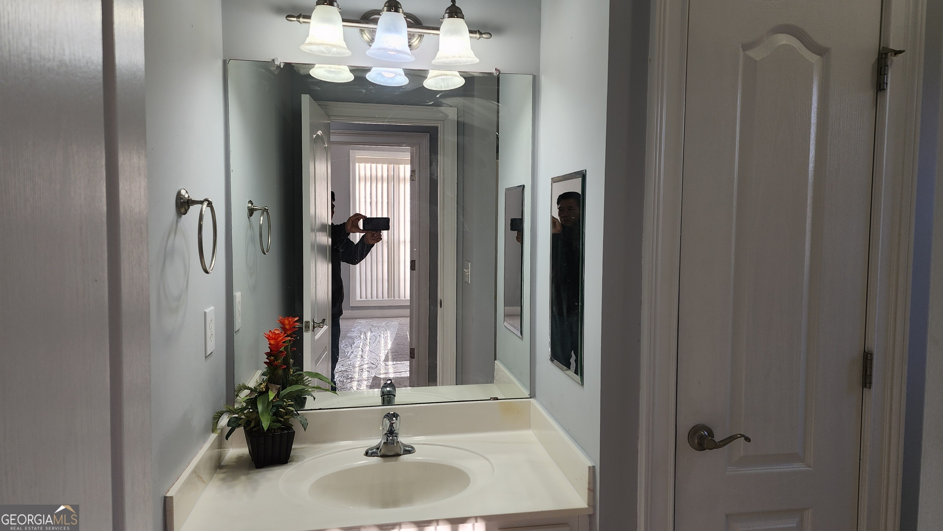 12123 Edgewater Drive Hampton, GA 30228 - Photo 26 of 44 a bathroom with a sink vanity and a mirror