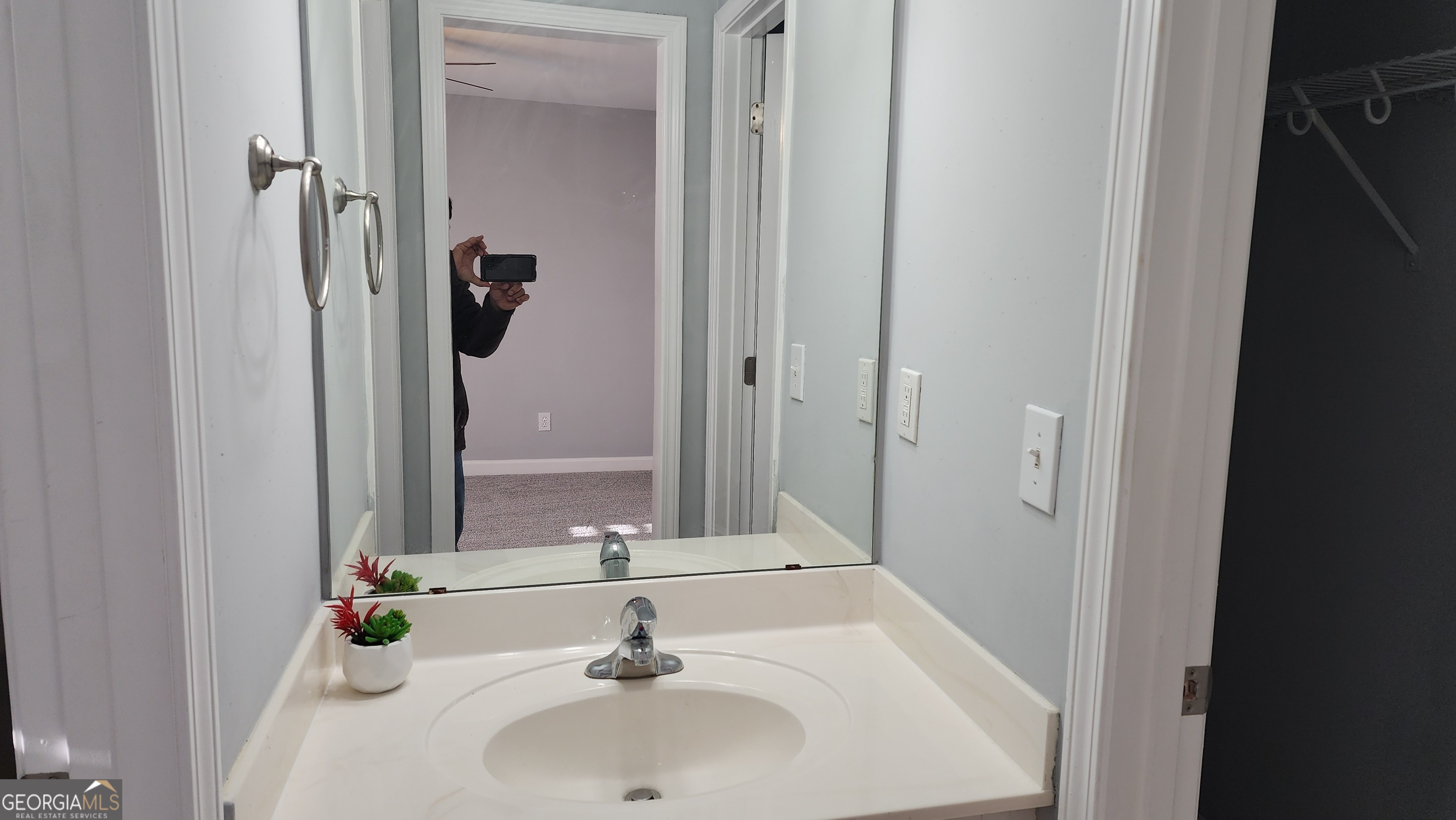12123 Edgewater Drive Hampton, GA 30228 - Photo 27 of 44 a bathroom with a sink and a mirror