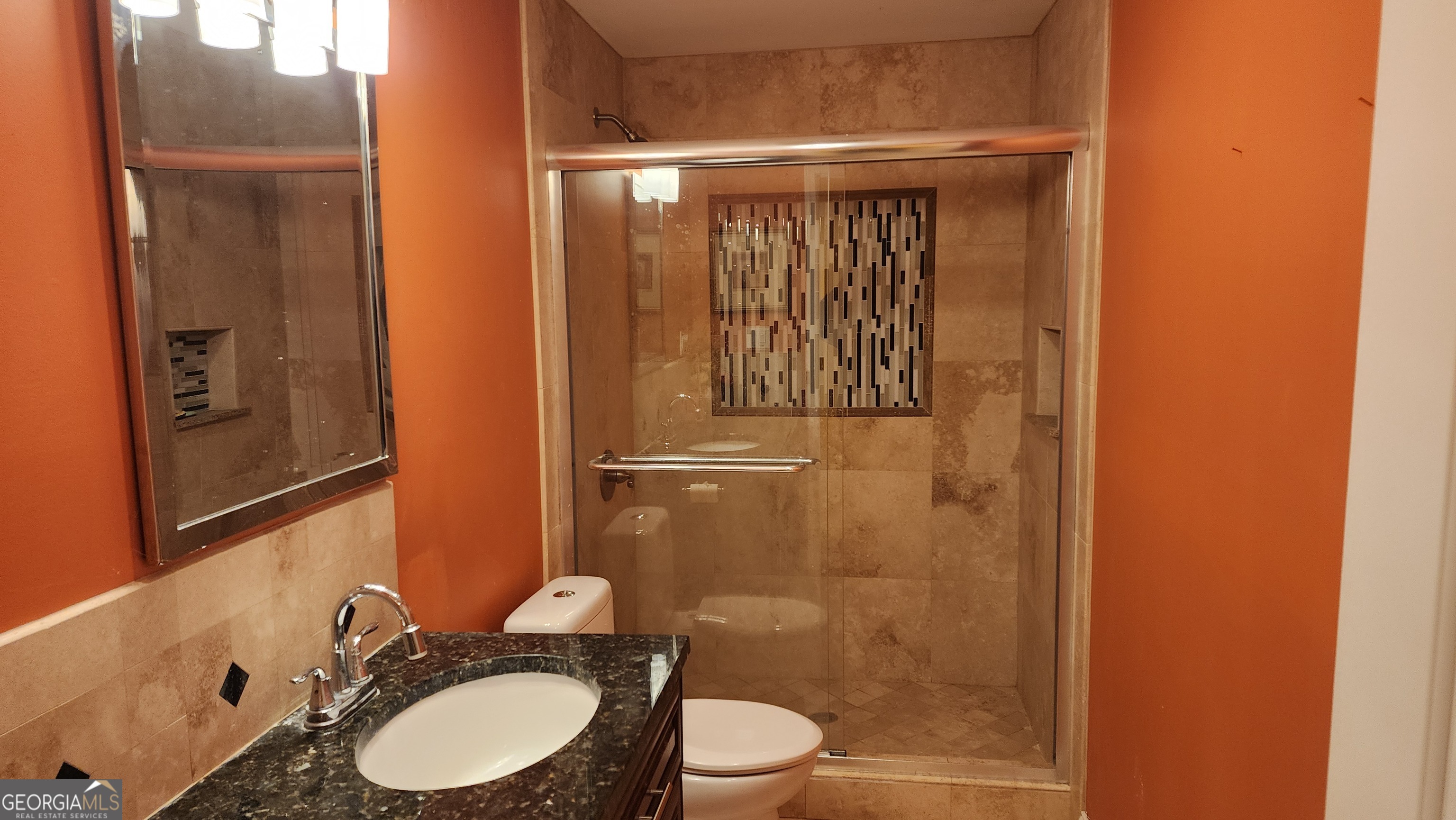 12123 Edgewater Drive Hampton, GA 30228 - Photo 32 of 44 a bathroom with a granite countertop sink toilet and shower