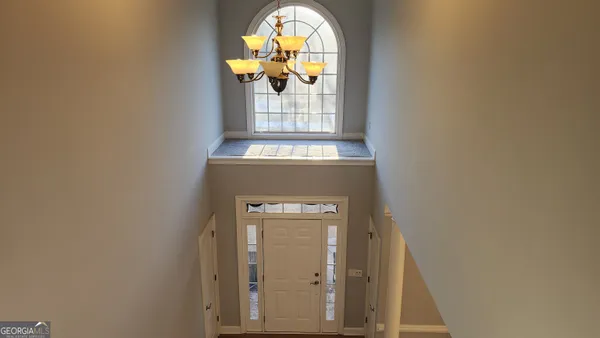 a view of staircase with wooden door