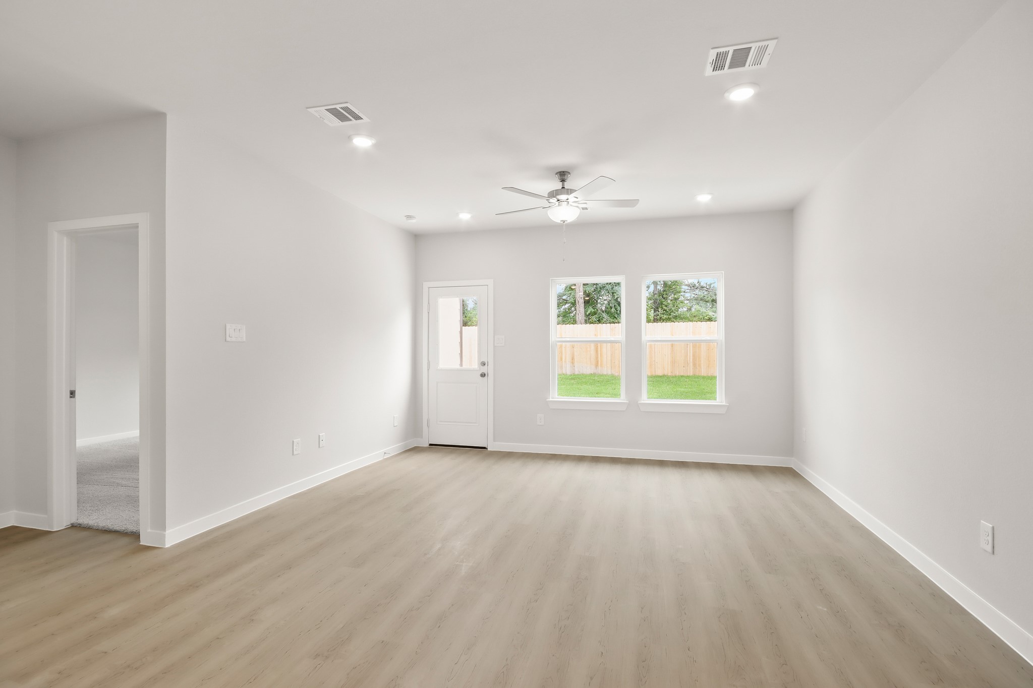 229 Spring Drive Hockley, TX 77447 - Photo 6 of 26 wooden floor in an empty room with a window