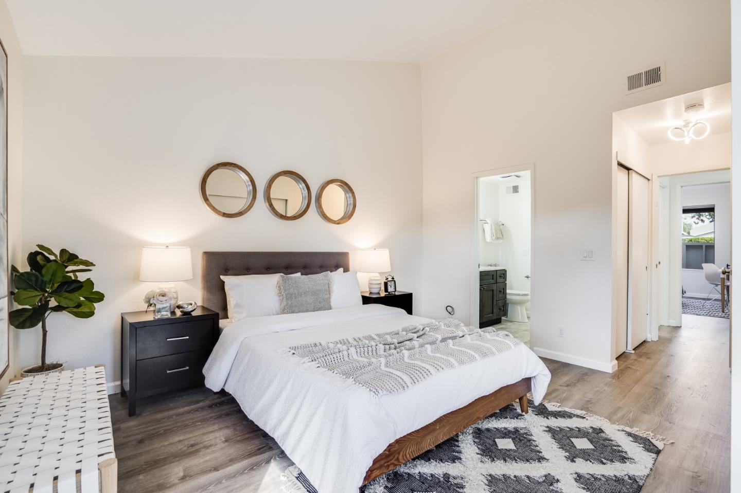 713 Comet Drive Foster City, CA 94404 - Photo 13 of 26 a bedroom with a large bed and a wooden floor