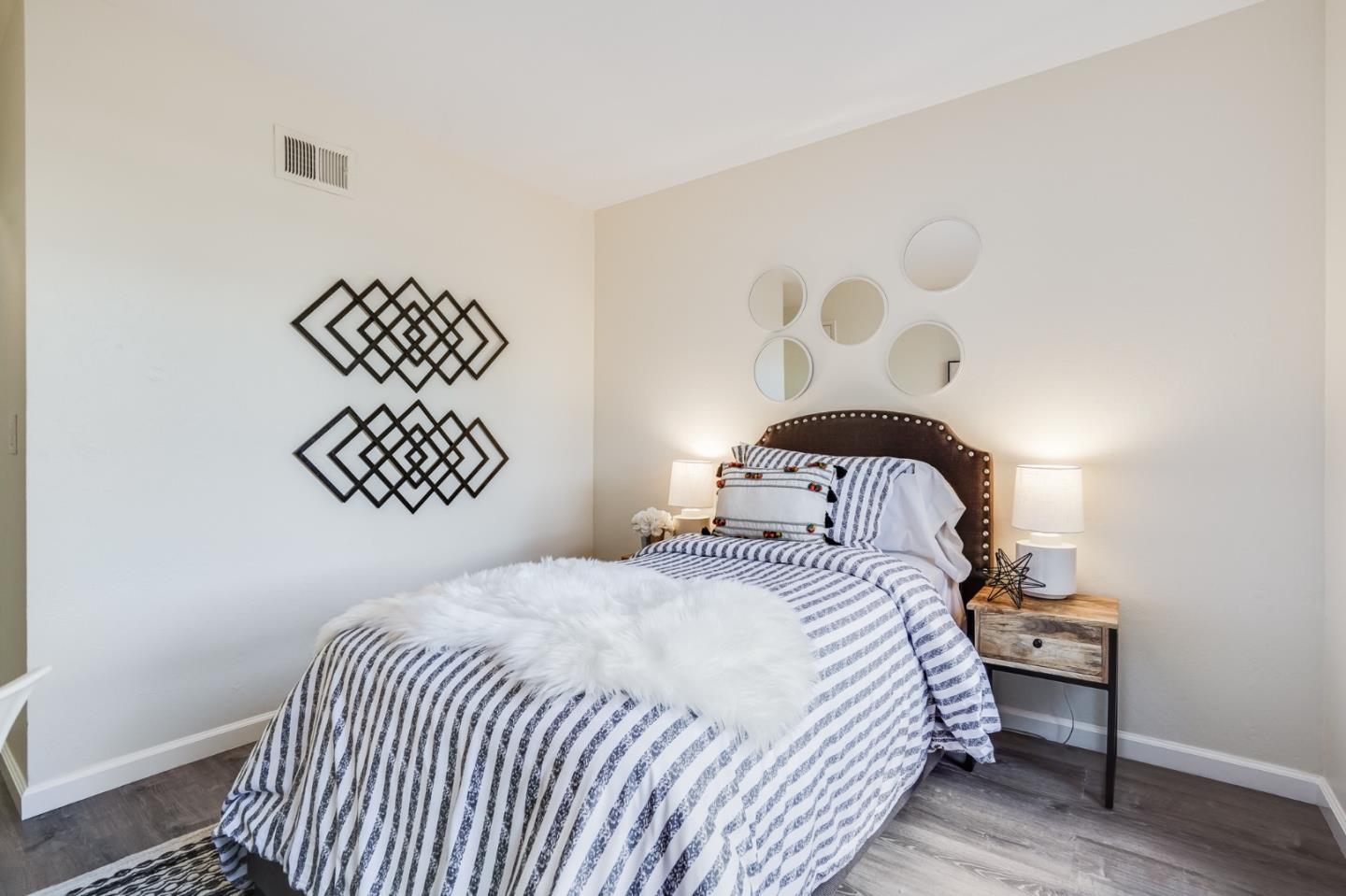 713 Comet Drive Foster City, CA 94404 - Photo 16 of 26 a bedroom with a bed and a lamp with wooden floor