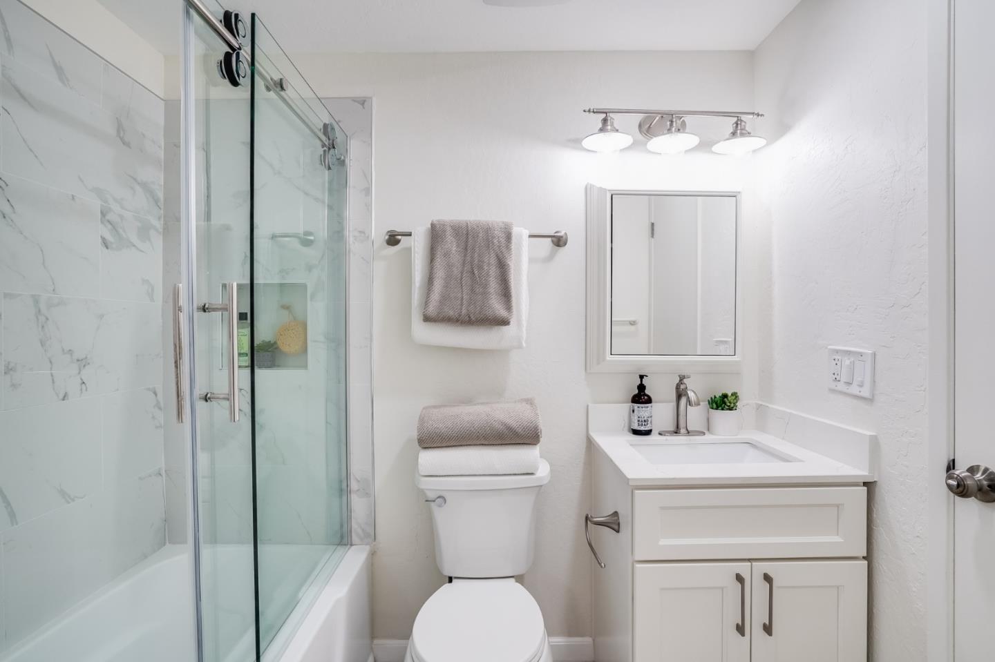 713 Comet Drive Foster City, CA 94404 - Photo 18 of 26 a bathroom with a toilet sink vanity and shower
