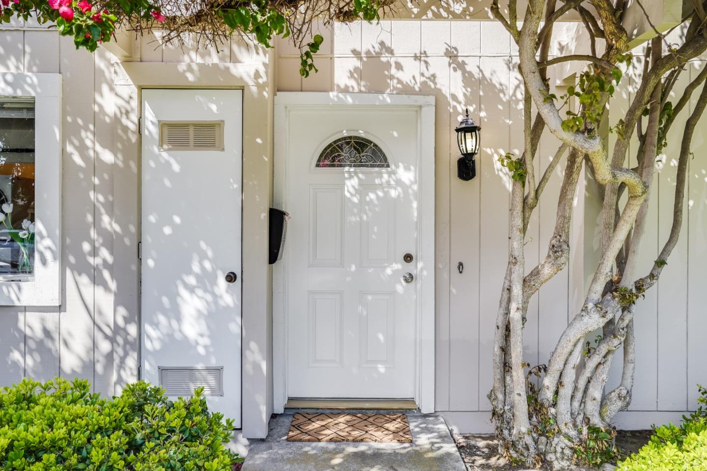 713 Comet Drive Foster City, CA 94404 - Photo 4 of 26 a view of a glass door with a tree in front