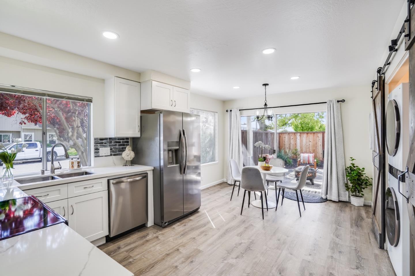 713 Comet Drive Foster City, CA 94404 - Photo 9 of 26 a kitchen with a table chairs refrigerator and a dining table