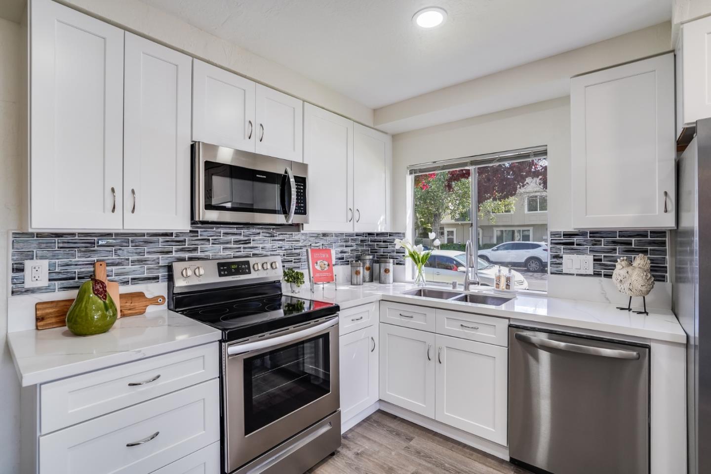 713 Comet Drive Foster City, CA 94404 - Photo 10 of 26 a kitchen with white cabinets and appliances