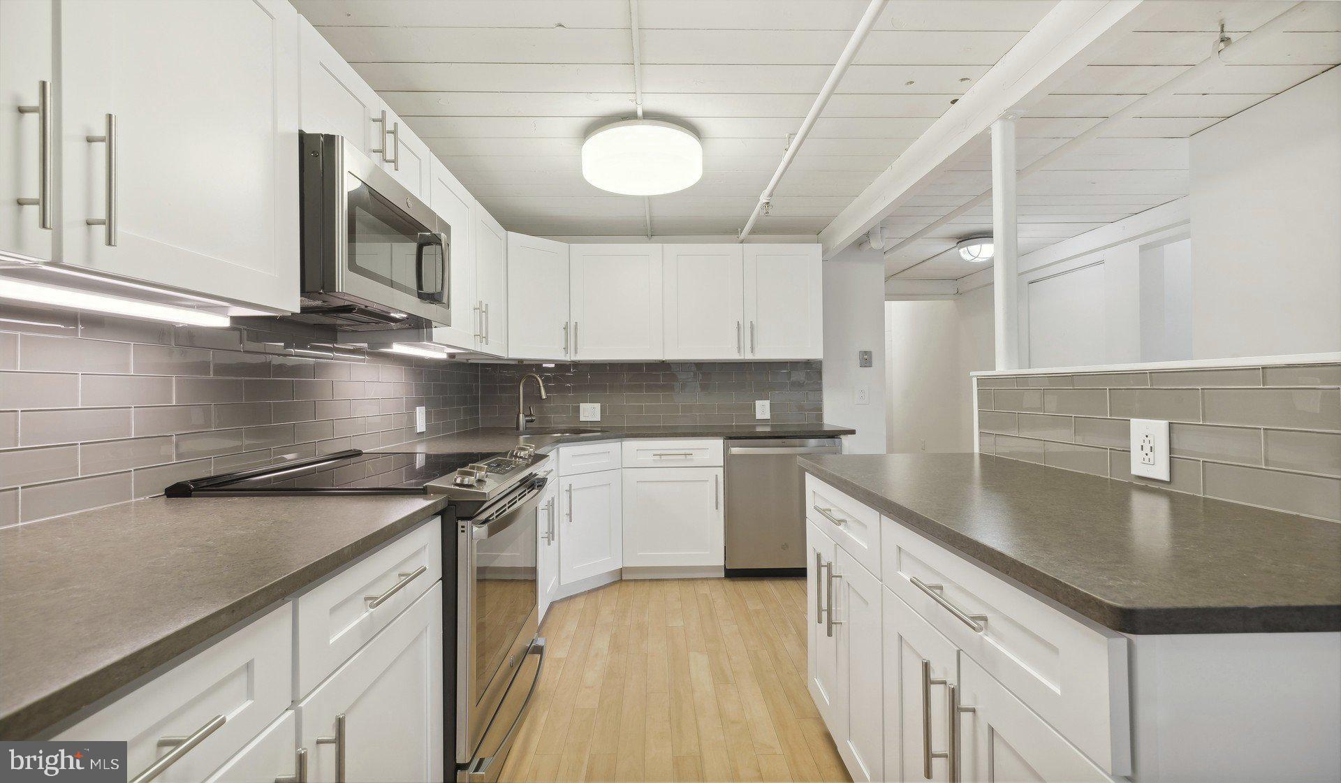 2300 Walnut Street, Unit 1B717 Philadelphia, PA 19103 - Photo 18 of 27 a kitchen with stainless steel appliances granite countertop a sink a stove and cabinets