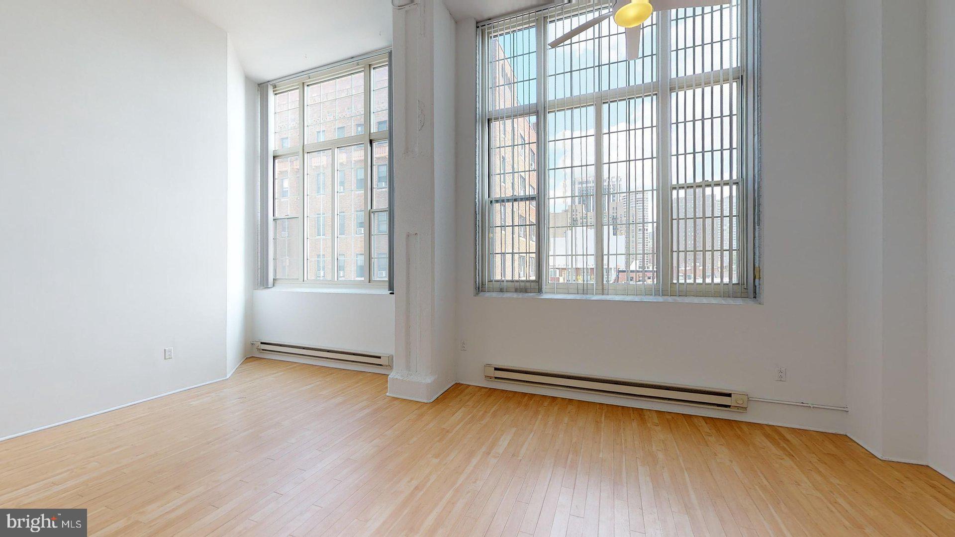 2300 Walnut Street, Unit 1B717 Philadelphia, PA 19103 - Photo 2 of 27 an empty room with wooden floor and windows