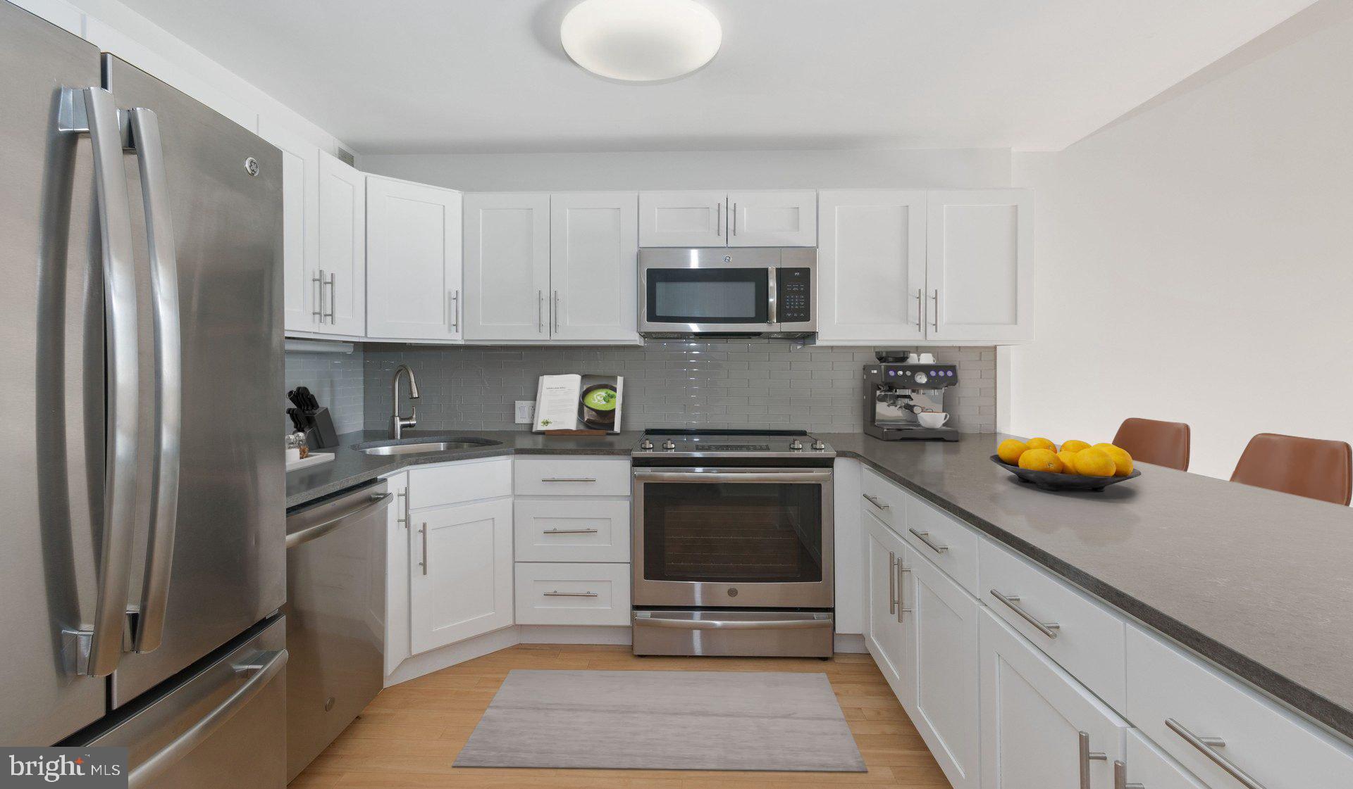 2300 Walnut Street, Unit 1B717 Philadelphia, PA 19103 - Photo 4 of 27 a kitchen with stainless steel appliances granite countertop a sink stove and refrigerator