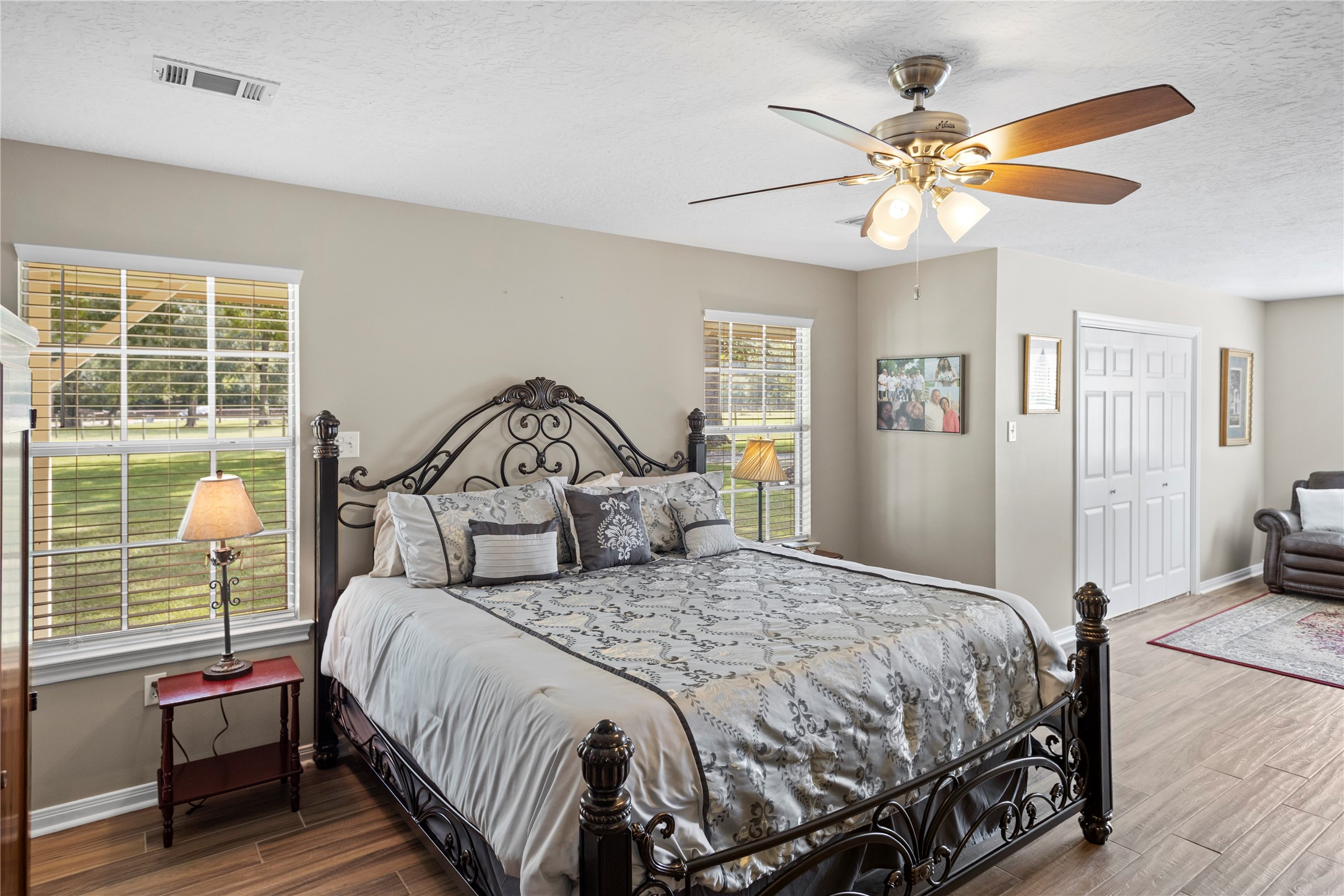 7875 Willys Road New Waverly, TX 77358 - Photo 17 of 45 a bedroom with a large bed and a chandelier