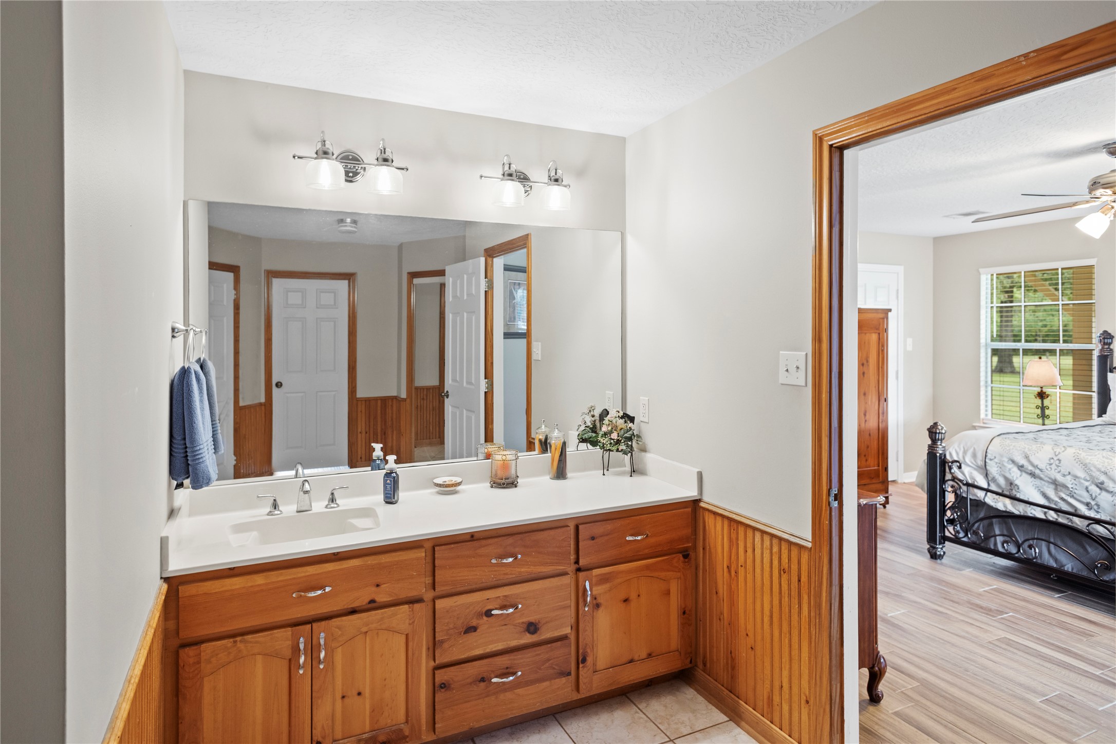 7875 Willys Road New Waverly, TX 77358 - Photo 20 of 45 a en suite bathroom with double sink and a mirror