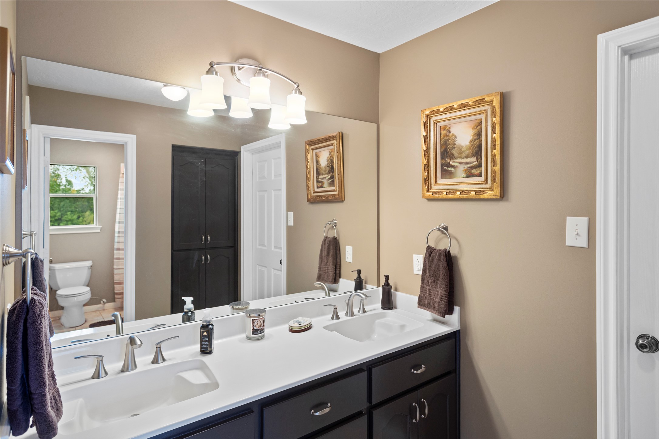 7875 Willys Road New Waverly, TX 77358 - Photo 25 of 45 a bathroom with a sink double vanity and a mirror