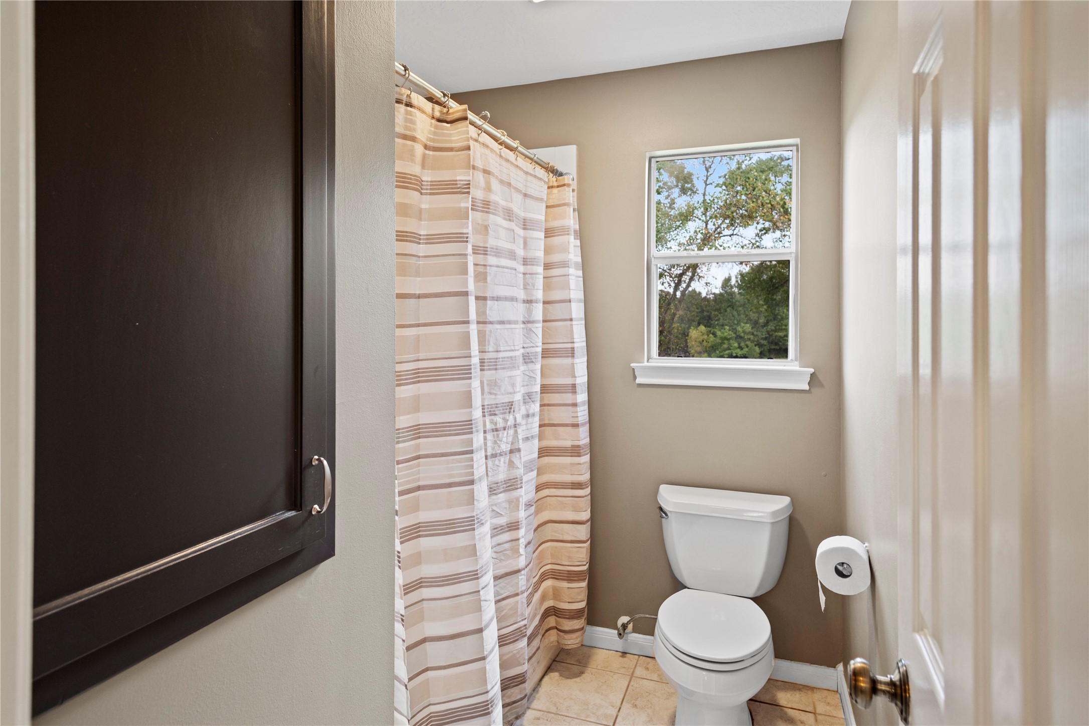 7875 Willys Road New Waverly, TX 77358 - Photo 26 of 45 a a bathroom with a toilet and a shower curtain
