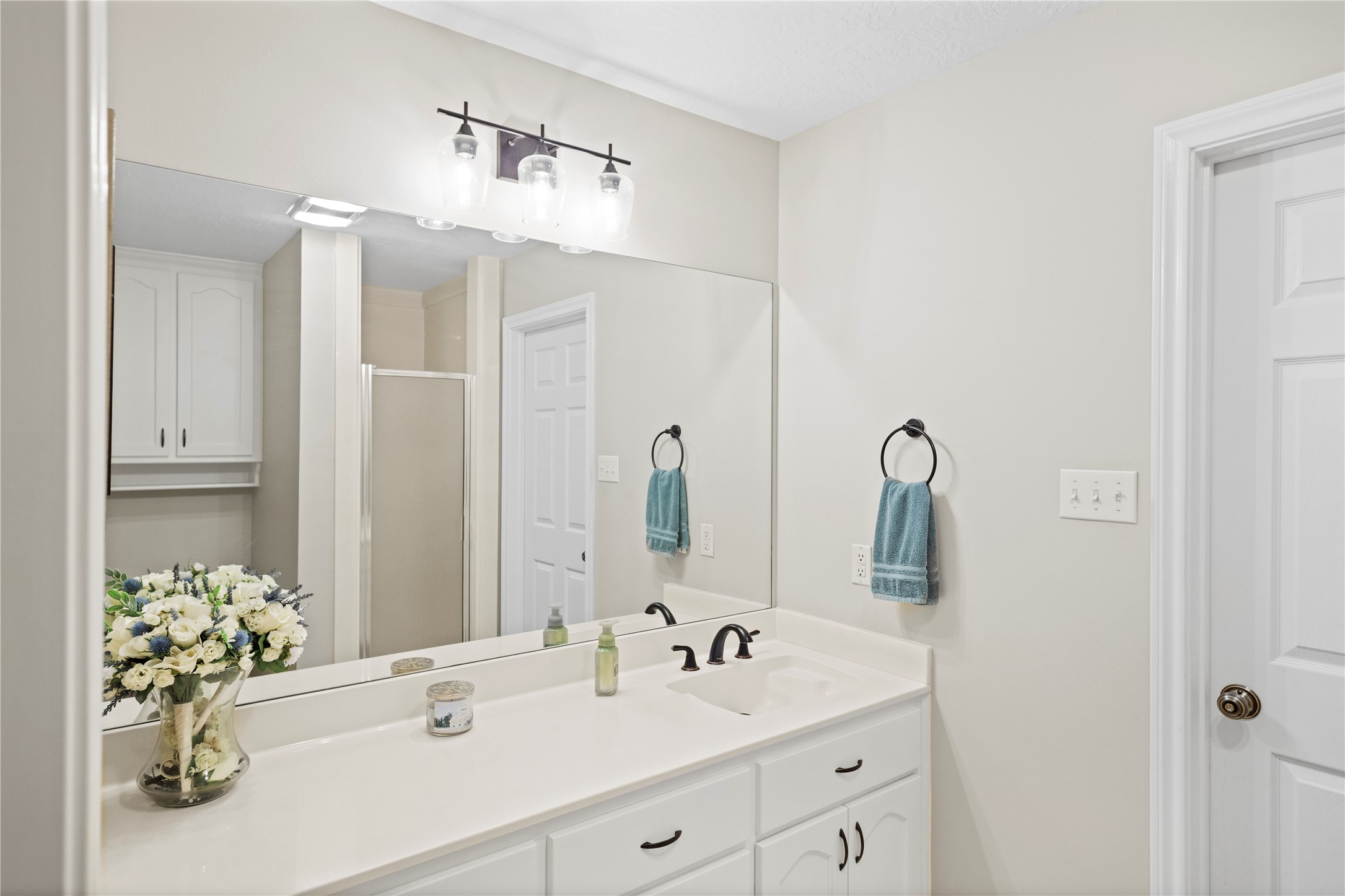 7875 Willys Road New Waverly, TX 77358 - Photo 28 of 45 a bathroom with a double vanity sink and a mirror