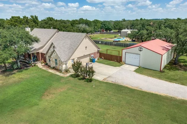 an aerial view of a house with a garden and houses