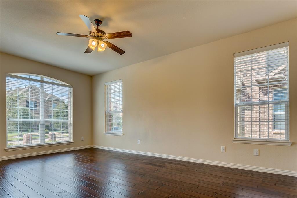 1180 Ranch Gate Lane Frisco, TX 75036 - Photo 13 of 40 a view of an empty room with wooden floor and a window