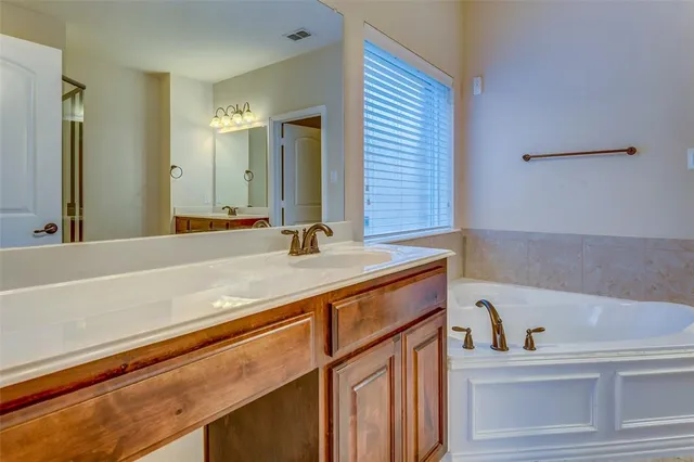 a bathroom with a bathtub and a sink