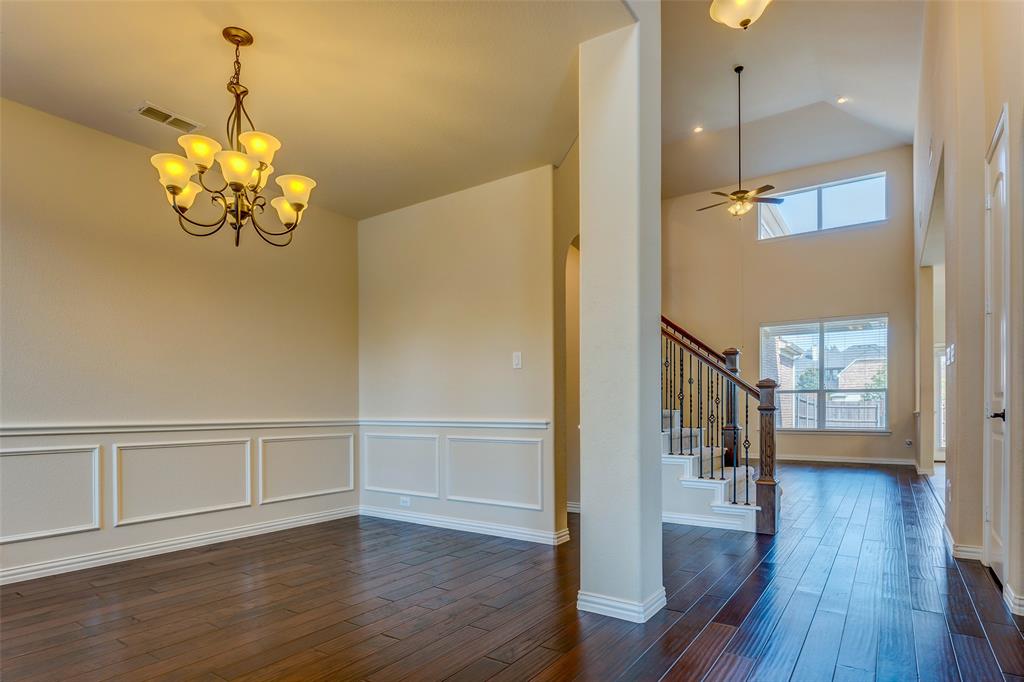 1180 Ranch Gate Lane Frisco, TX 75036 - Photo 5 of 40 a view of an empty room with wooden floor and a window