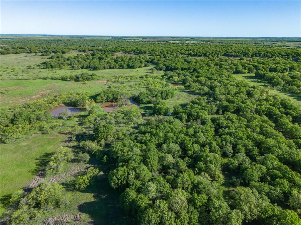 3760 Dewebber Road Bowie, TX 76230 - Photo 13 of 35 an aerial view of residential houses with outdoor space and trees