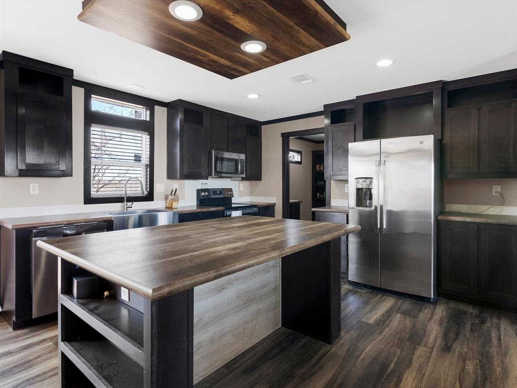 3760 Dewebber Road Bowie, TX 76230 - Photo 23 of 35 a kitchen with a stove a refrigerator and a microwave
