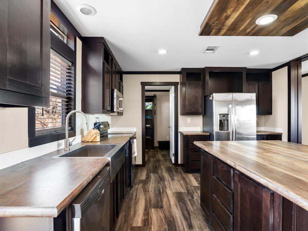 3760 Dewebber Road Bowie, TX 76230 - Photo 24 of 35 a kitchen with lots of counter space and painting on the wall
