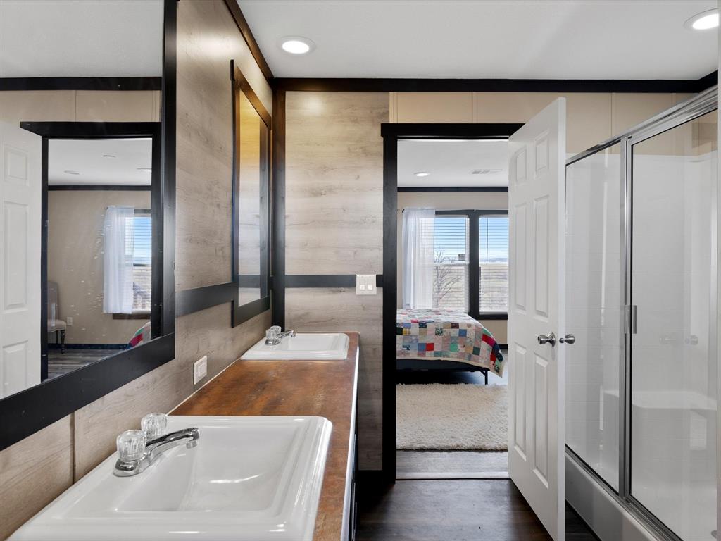 3760 Dewebber Road Bowie, TX 76230 - Photo 28 of 35 a en suite bathroom with a tub and a large mirror