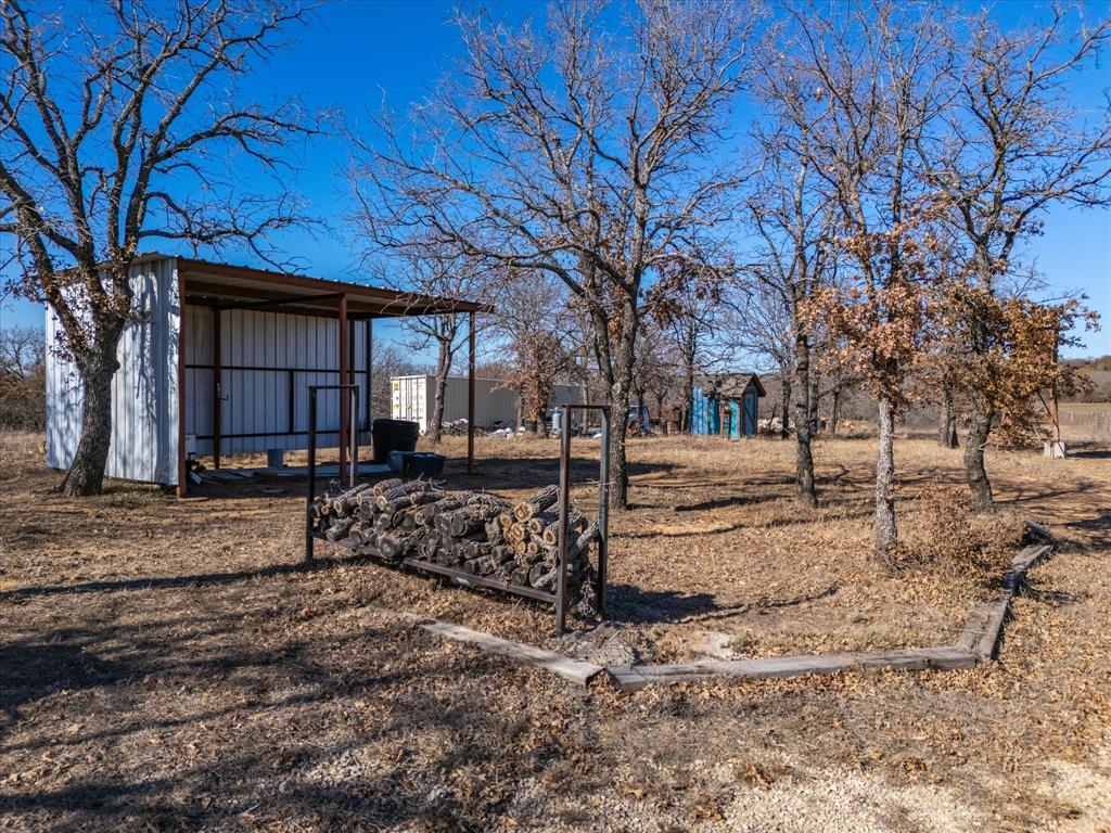 3760 Dewebber Road Bowie, TX 76230 - Photo 30 of 35 a view of a house with a yard covered in snow