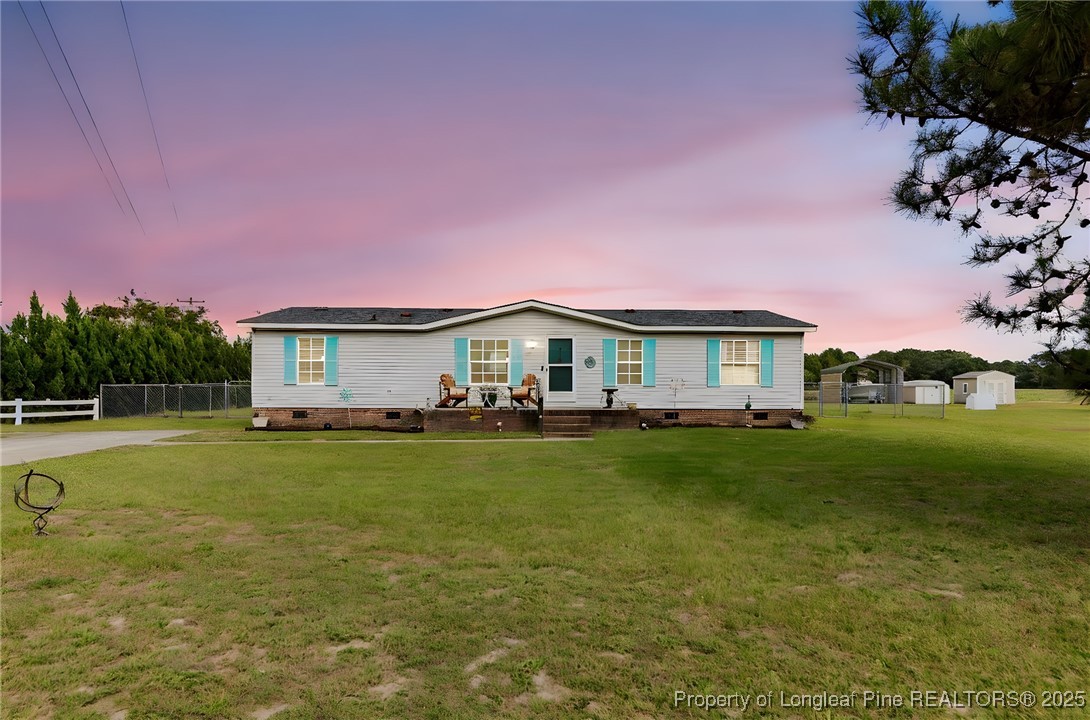 3376 Wade-Stedman Road Wade, NC 28395 - Photo 1 of 35 a front view of a house with garden