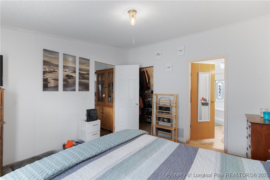 3376 Wade-Stedman Road Wade, NC 28395 - Photo 15 of 35 a bedroom with a bed and a window