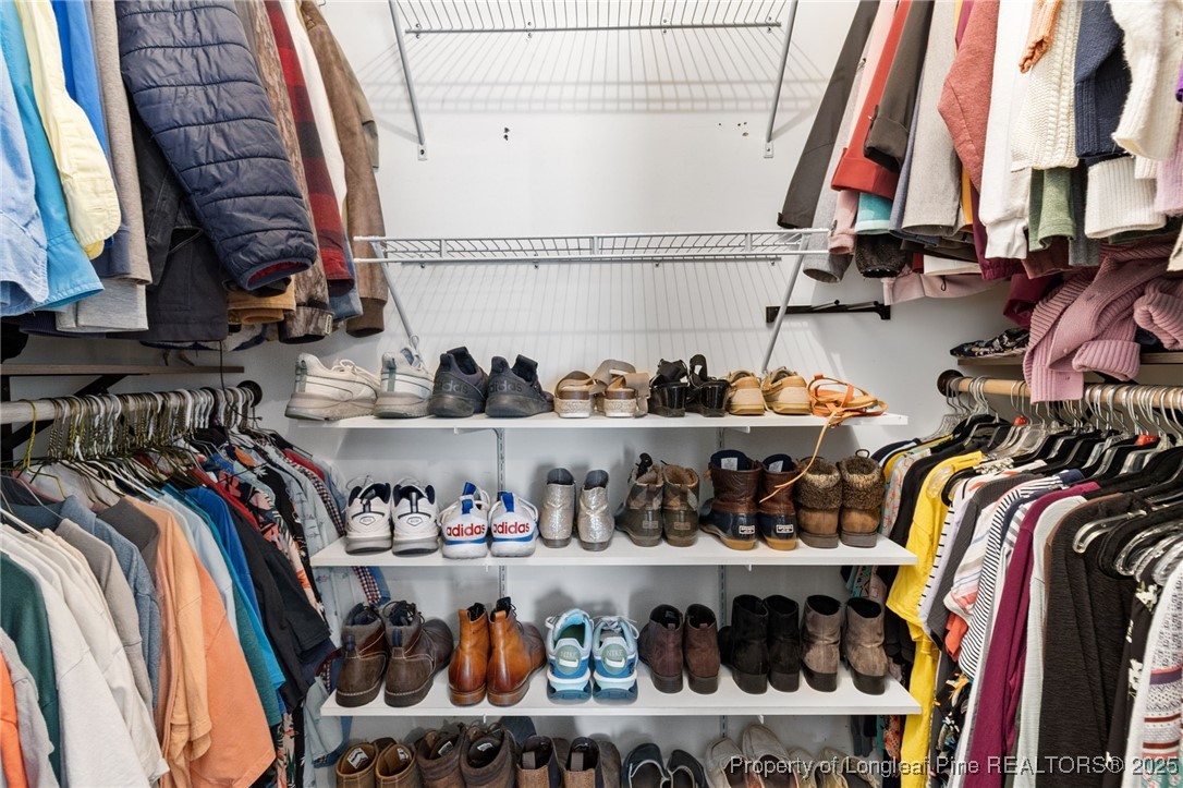 3376 Wade-Stedman Road Wade, NC 28395 - Photo 16 of 35 a view of walk in closet with clothes and shoes