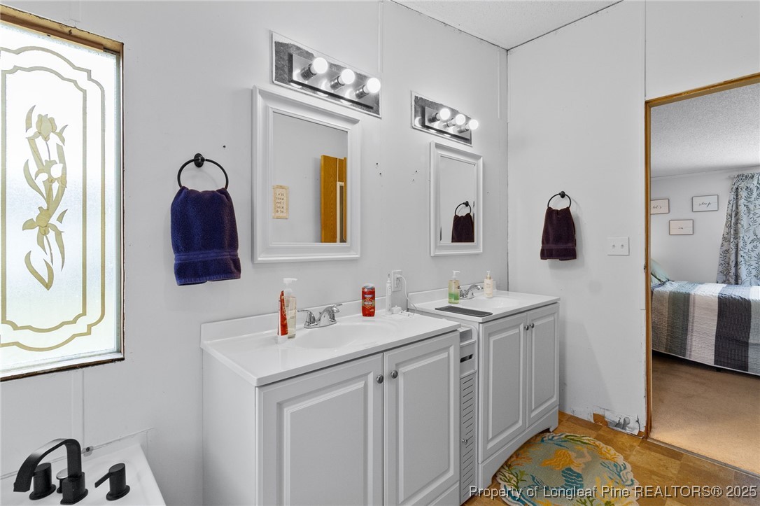 3376 Wade-Stedman Road Wade, NC 28395 - Photo 17 of 35 a bathroom with a sink and a mirror