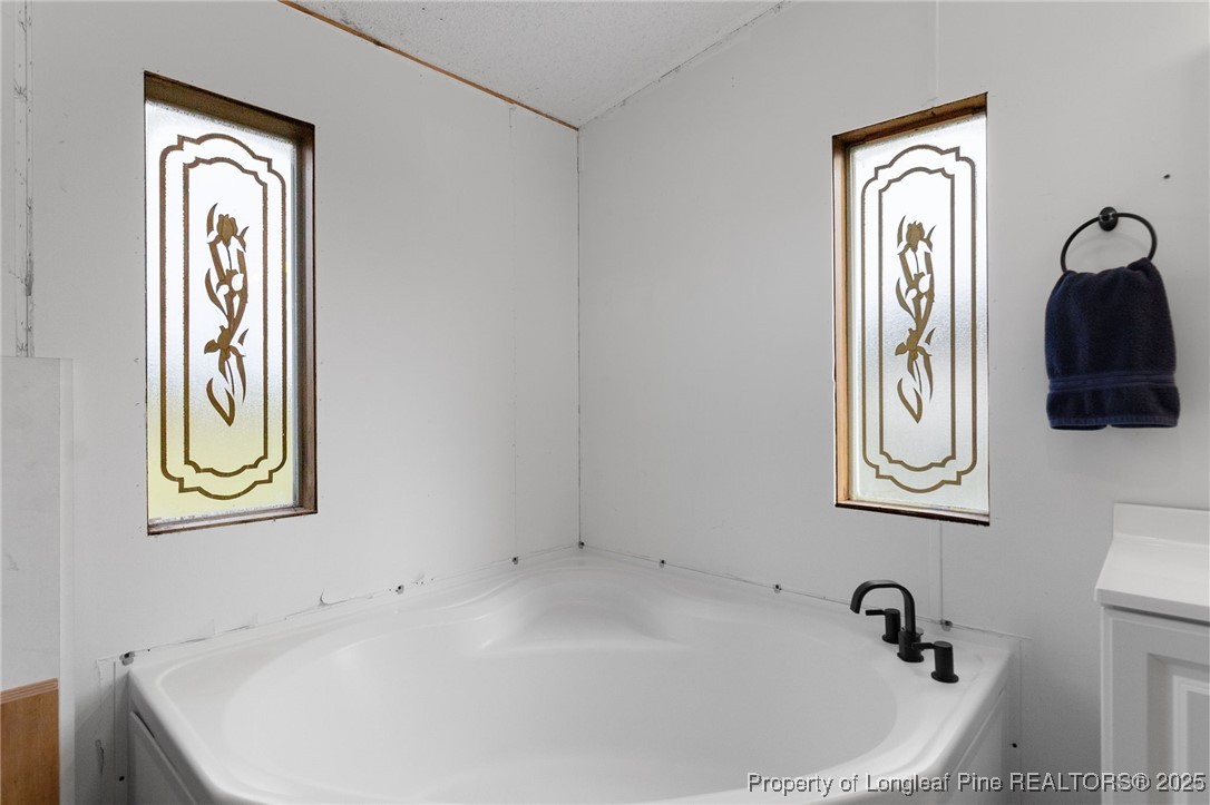 3376 Wade-Stedman Road Wade, NC 28395 - Photo 18 of 35 a bathroom with a sink and a window