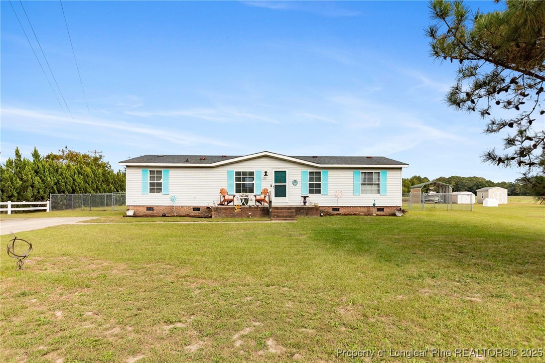 3376 Wade-Stedman Road Wade, NC 28395 - Photo 2 of 35 a front view of house with yard and trees